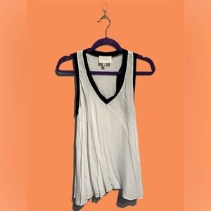 🌸The Coverii, sleeveless shirt. White  with black hem. Size small.